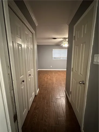 a view of a room with wooden floor and a window