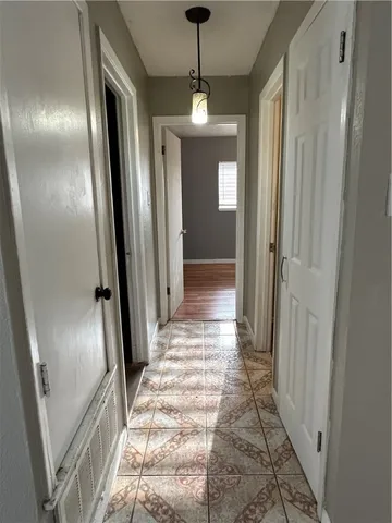 a view of a hallway with windows and stairs