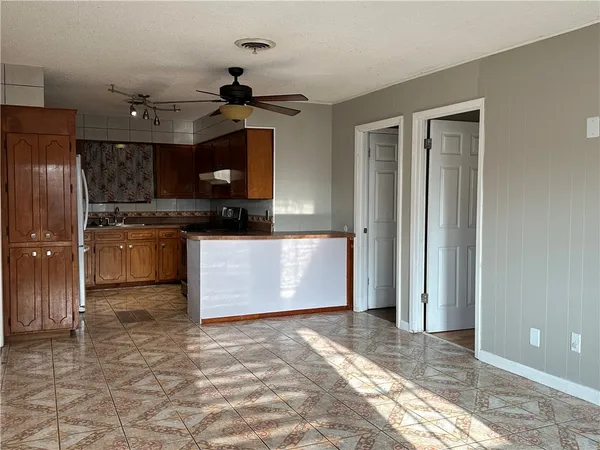 a view of a kitchen with a sink and a refrigerator
