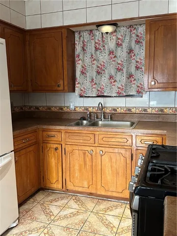 a kitchen with stainless steel appliances granite countertop a refrigerator and sink