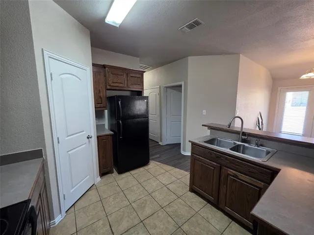 a kitchen with a sink stove and refrigerator
