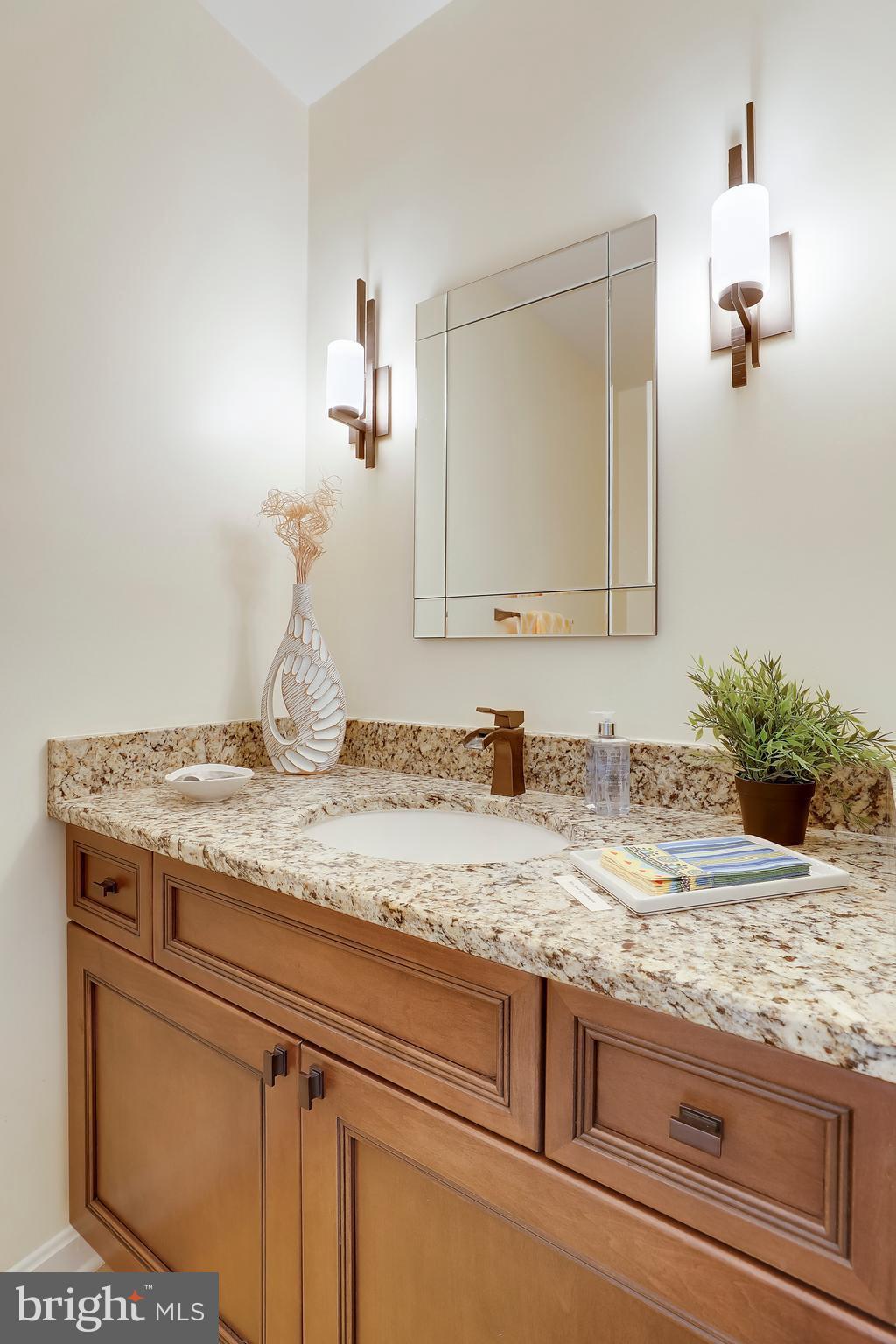 1476 Sharps Point Road Annapolis, MD 21409 - Photo 15 of 30 a bathroom with a granite countertop sink and a mirror