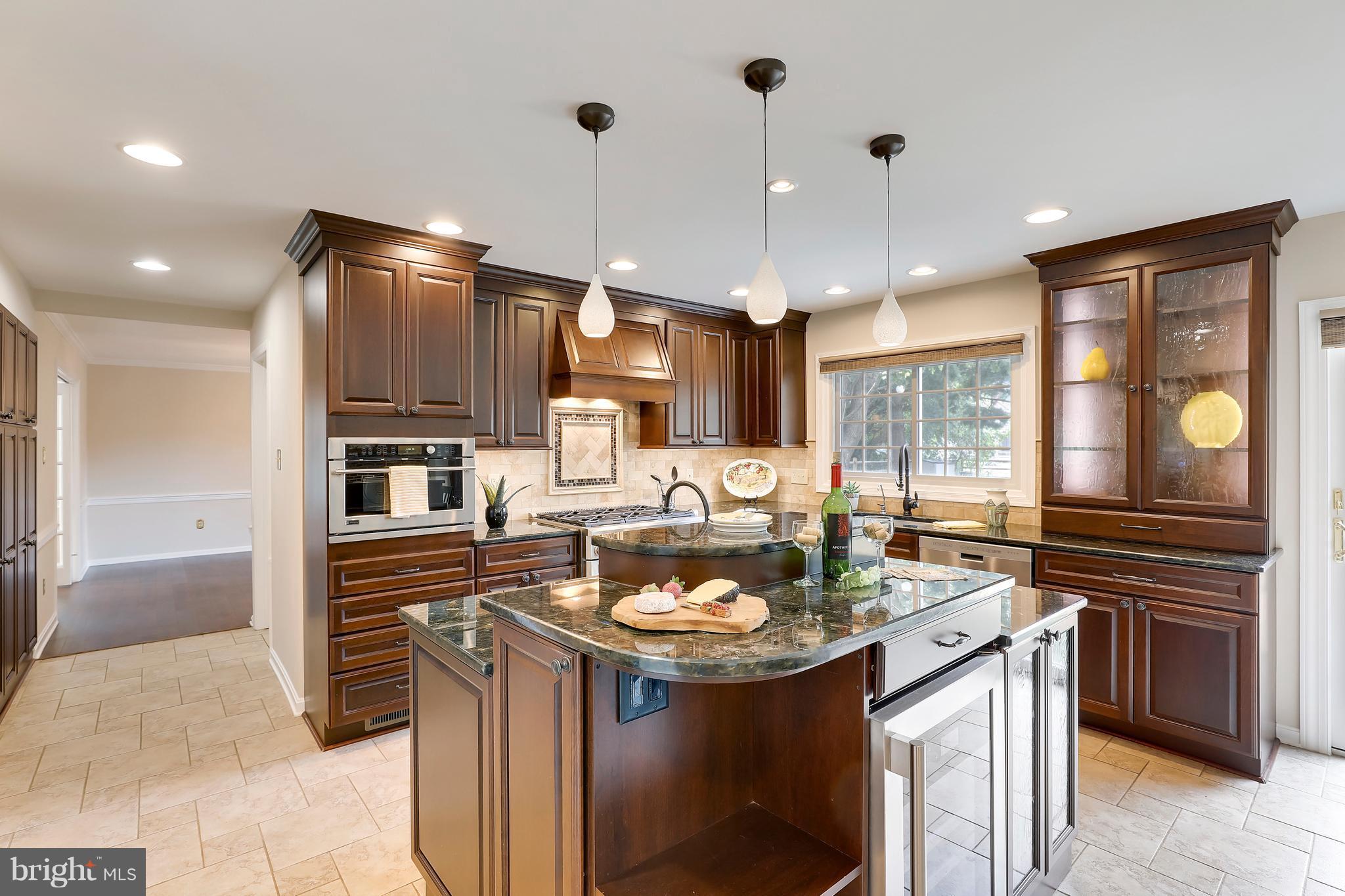 1476 Sharps Point Road Annapolis, MD 21409 - Photo 5 of 30 a kitchen with a sink stove and cabinets