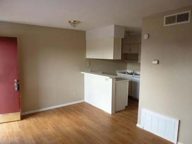 a view of kitchen with stove and wooden floor