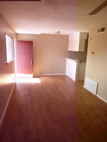 a view of a room with an empty space and a window