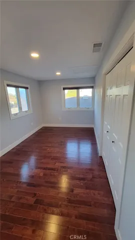 a bathroom with a sink a toilet a mirror and shower
