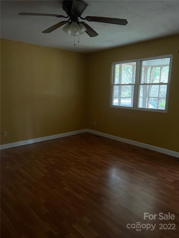 313 Old Barn Road Gold Hill, NC 28071 - Photo 5 of 9 a view of an empty room with wooden floor and a window
