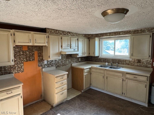 554 R Canton Road Steubenville, OH 43953 - Photo 4 of 15 Kitchen with cream cabinets, tile patterned floors, tasteful backsplash, sink, and a textured ceiling