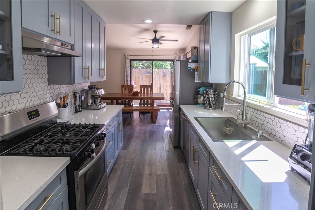 1 San Ramon Drive Chico, CA 95973 - Photo 3 of 42 a kitchen with lots of counter top space a sink appliances and cabinets