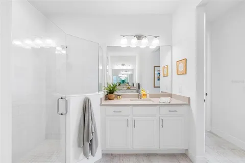 a bathroom with a sink vanity and mirror