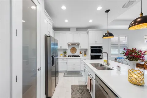 a kitchen with counter top space cabinets and stainless steel appliances