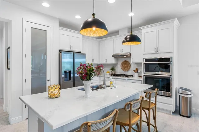 a kitchen with a dining table and chairs