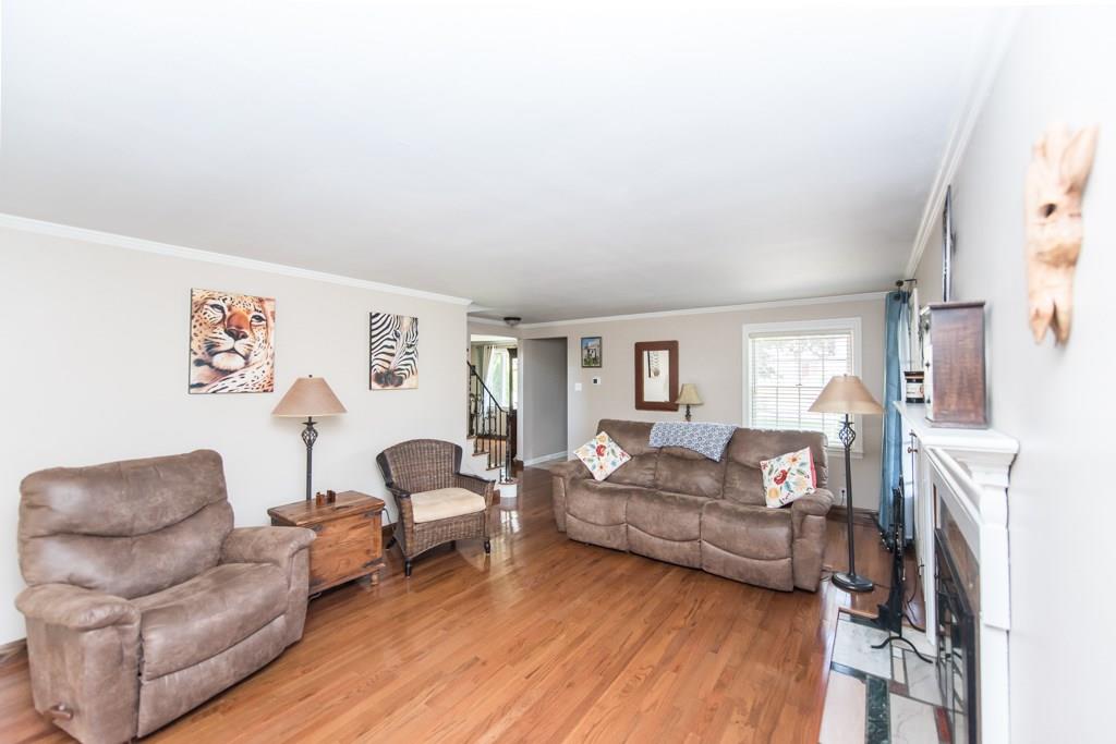 171 Pine Road Pittsburgh, PA 15237 - Photo 3 of 25 This cozy living room features neutral paint, hardwood floors, crown moulding and a lovely fireplace.