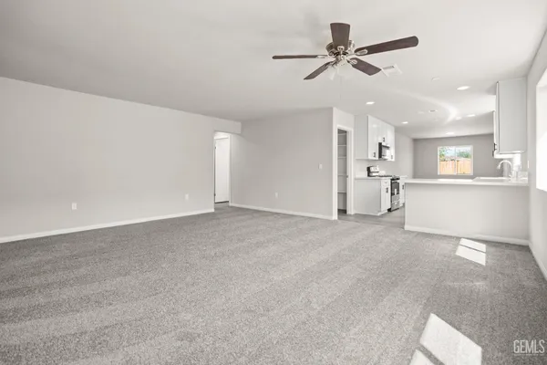 a large white kitchen with a sink