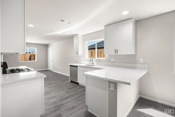 a kitchen with a sink stove and cabinets