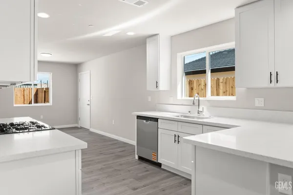 a large white kitchen with cabinets