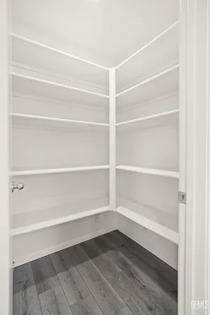 a kitchen with white cabinets and sink