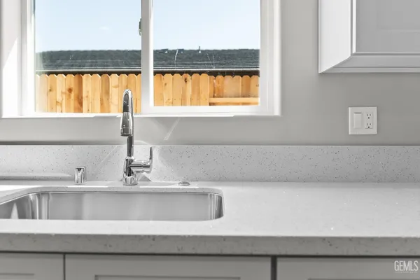 a kitchen with granite countertop a stove and a microwave