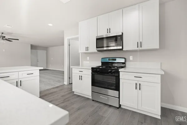 a kitchen with stainless steel appliances a sink stove and cabinets