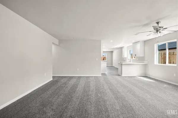 a view of empty room with wooden floor and windows