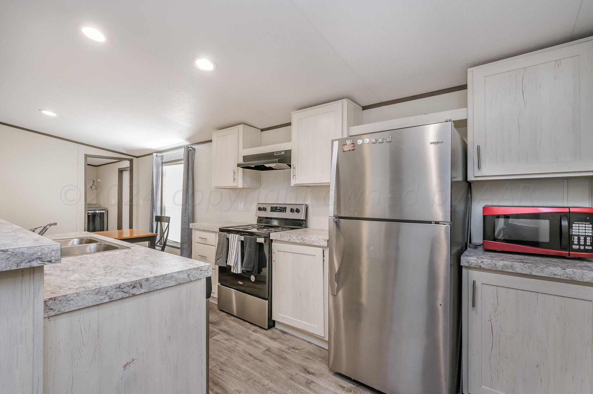 11901 Ls Trail Amarillo, TX 79118 - Photo 2 of 14 a kitchen with stainless steel appliances granite countertop a refrigerator stove and sink