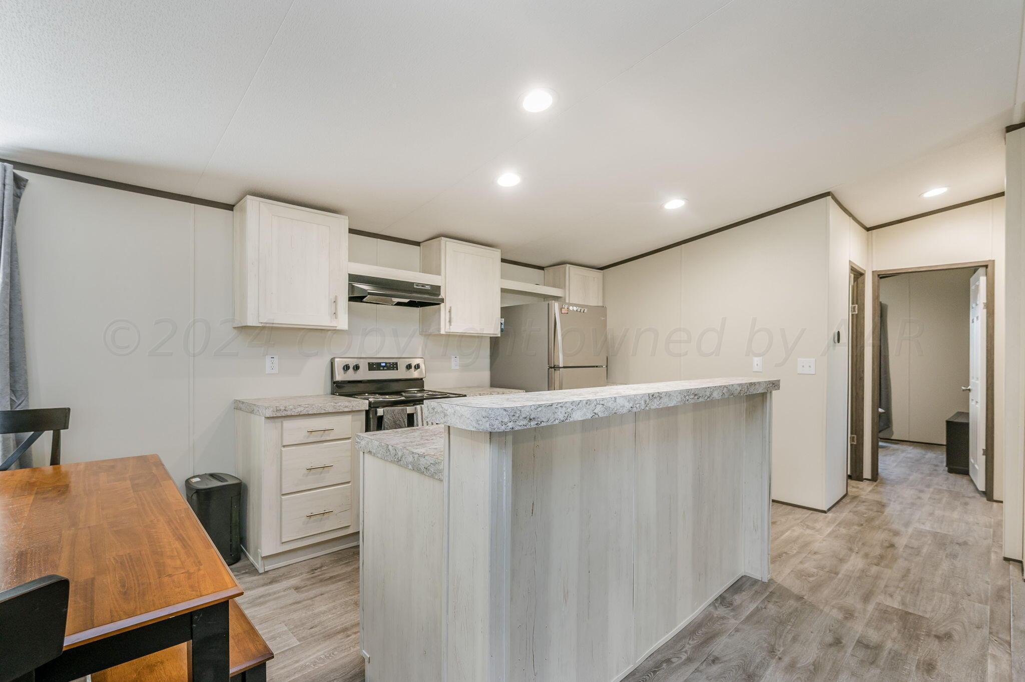 11901 Ls Trail Amarillo, TX 79118 - Photo 3 of 14 a kitchen with stainless steel appliances granite countertop a sink stove and refrigerator
