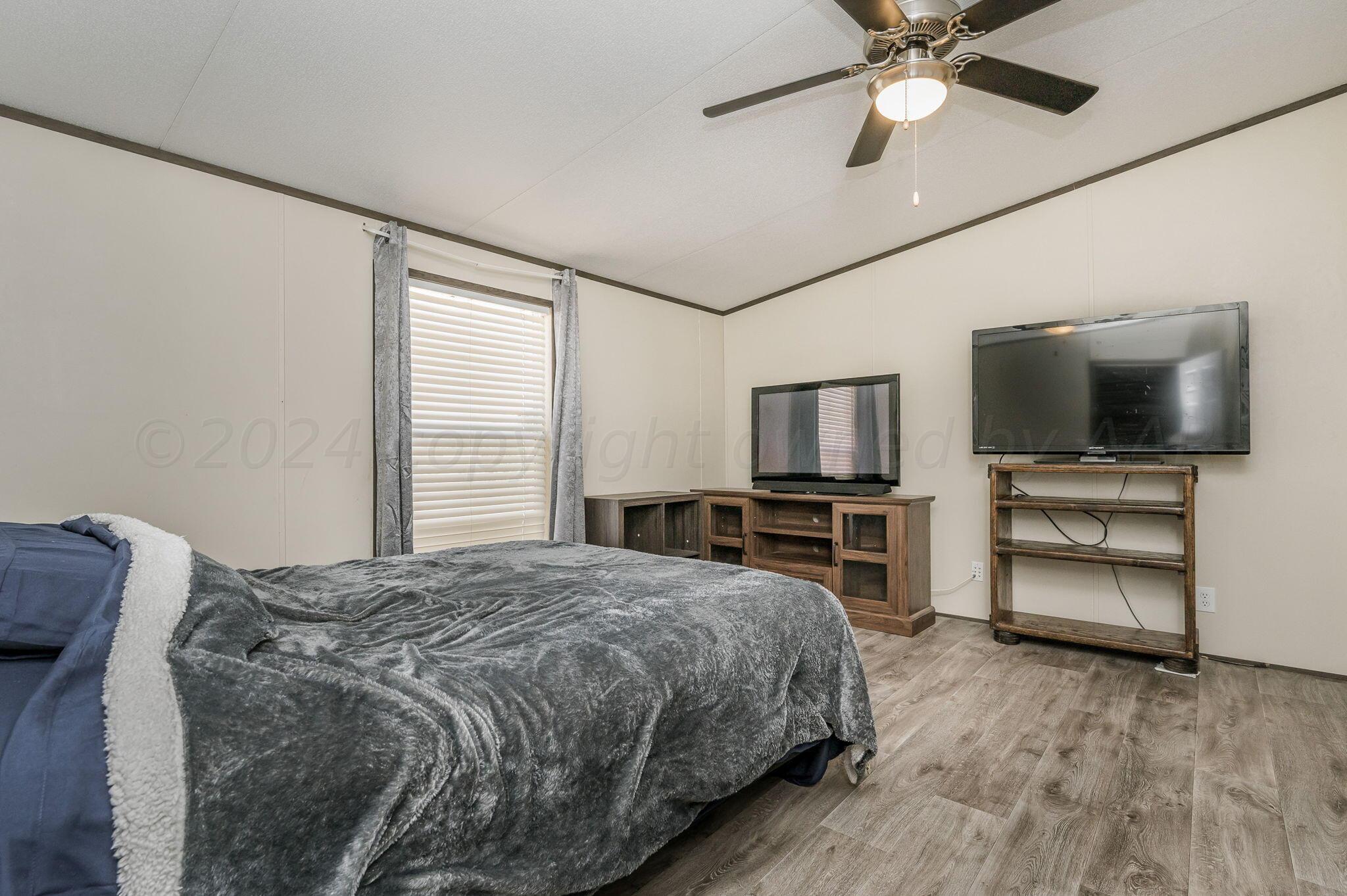 11901 Ls Trail Amarillo, TX 79118 - Photo 6 of 14 a bedroom with a bed and a flat screen tv