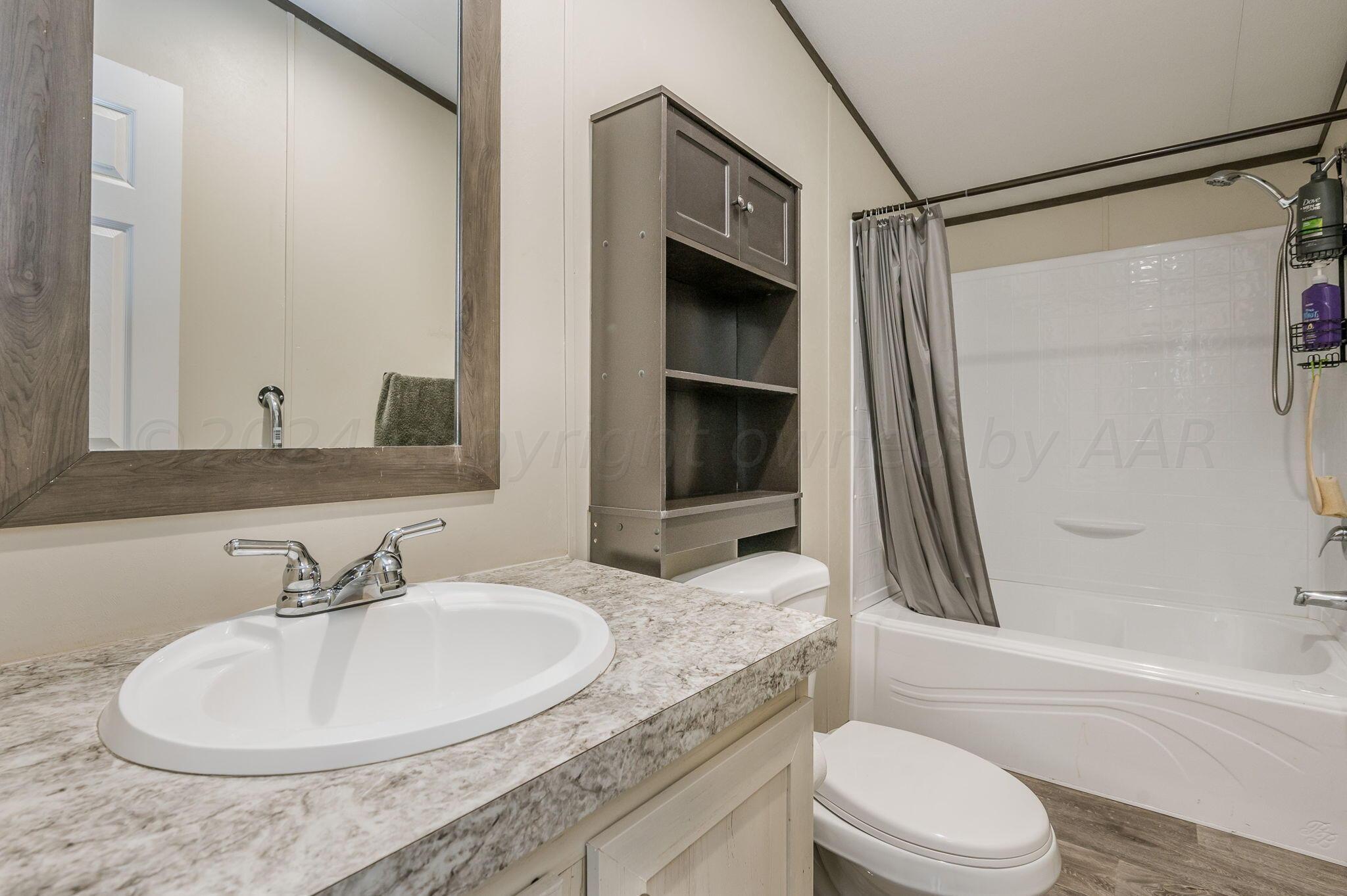 11901 Ls Trail Amarillo, TX 79118 - Photo 7 of 14 a bathroom with a granite countertop sink toilet and shower