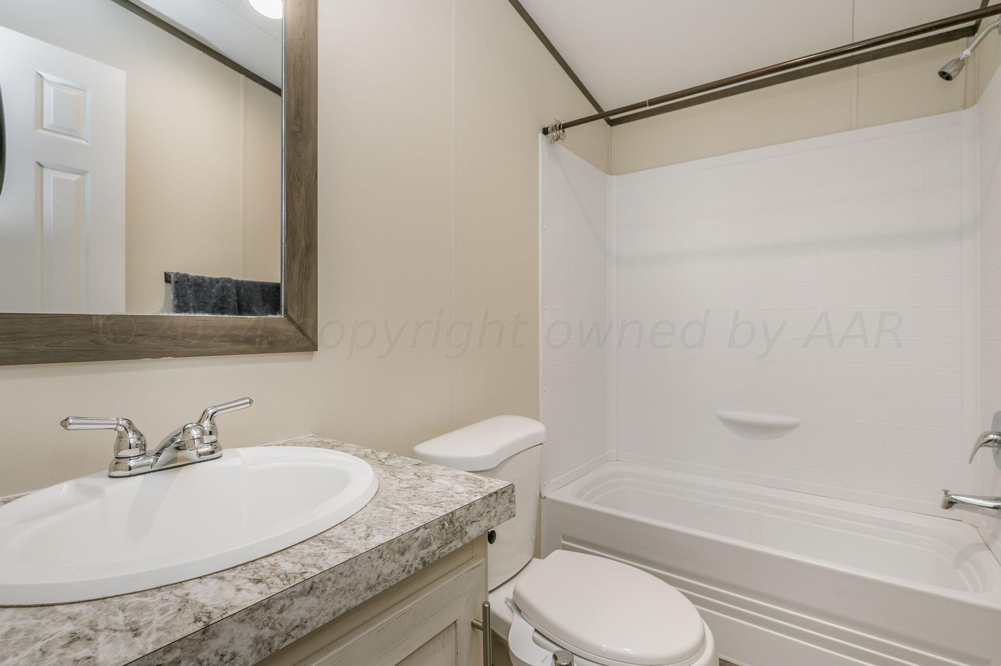 11901 Ls Trail Amarillo, TX 79118 - Photo 10 of 14 a bathroom with a granite countertop toilet sink and bathtub