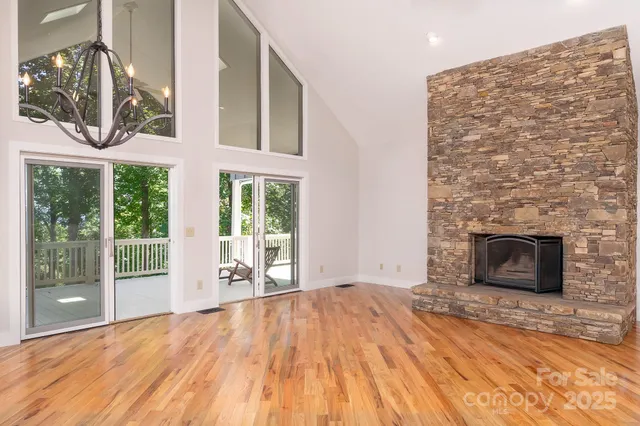 a view of empty room with wooden floor and fireplace