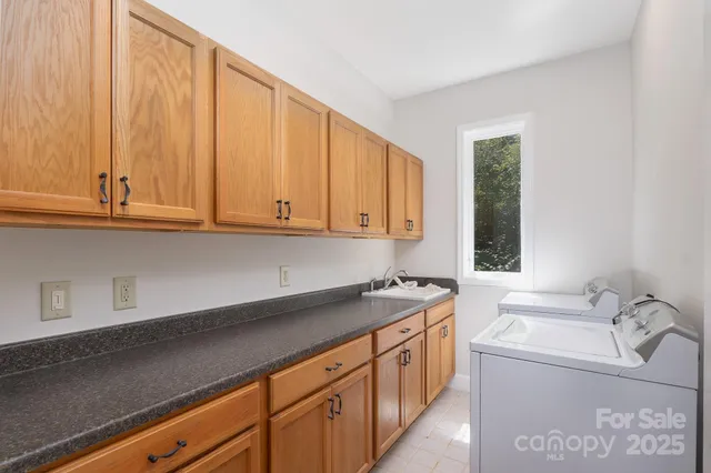a kitchen with stainless steel appliances granite countertop a sink a stove and a microwave