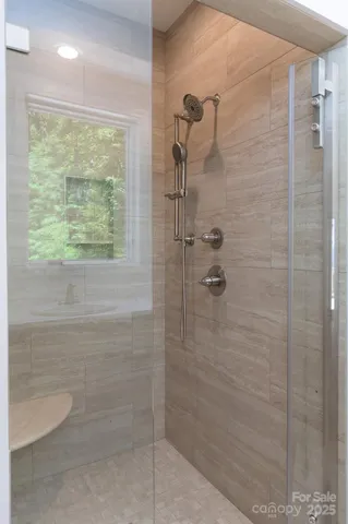 a bathroom with a double vanity sink and mirror with shower