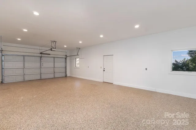 an empty room with ceiling fan and window