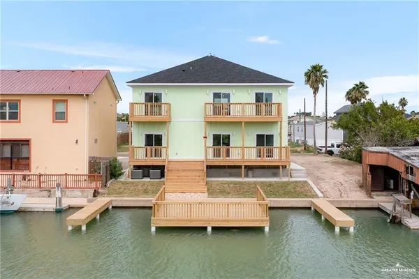 a view of a house with swimming pool and sitting area