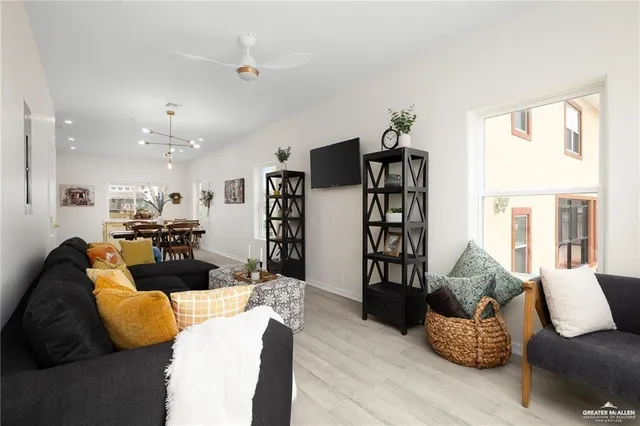 a living room with furniture and wooden floor