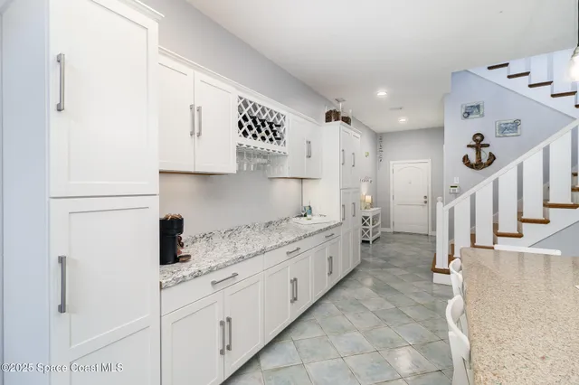 a spacious bedroom with a bed and dresser with wooden floor