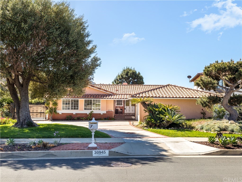30945 Rue Valois Rancho Palos Verdes, CA 90275 - Photo 1 of 1 a front view of a house with a garden and tree