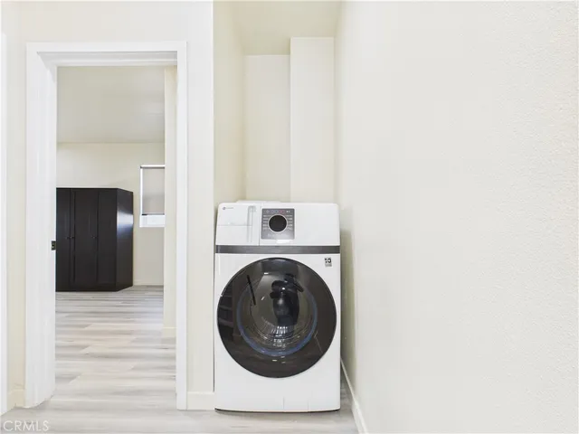 a view of a hallway with washer and dryer