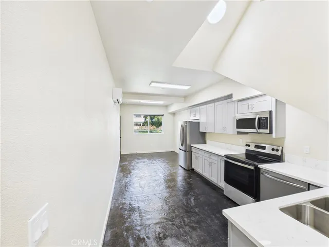a kitchen with stainless steel appliances granite countertop a sink and stove top oven