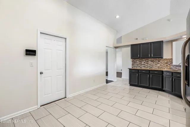 a large white kitchen with a stove a sink and a refrigerator