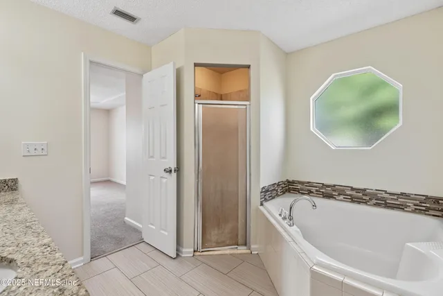 a bathroom with a tub and a shower