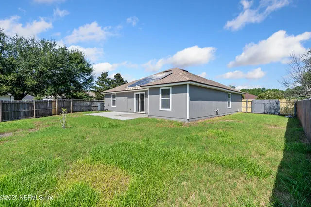 a view of a house with a yard and sitting area