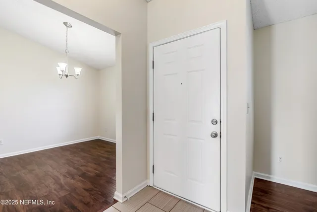 an empty room with wooden floor