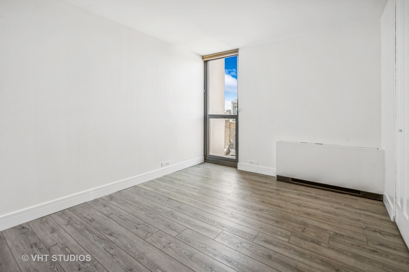 1850 North Clark Street, Unit 503 Chicago, IL 60614 - Photo 15 of 24 a view of an empty room and wooden floor