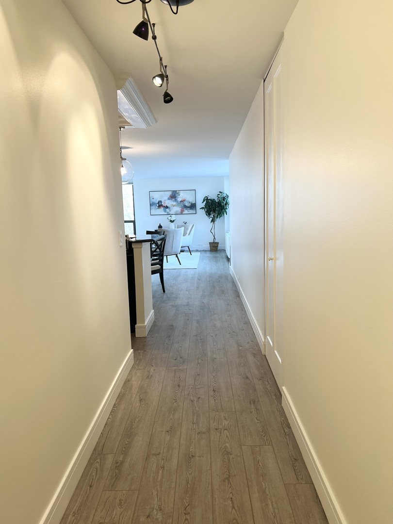 1850 North Clark Street, Unit 503 Chicago, IL 60614 - Photo 2 of 24 a view of a hallway with wooden floor and staircase