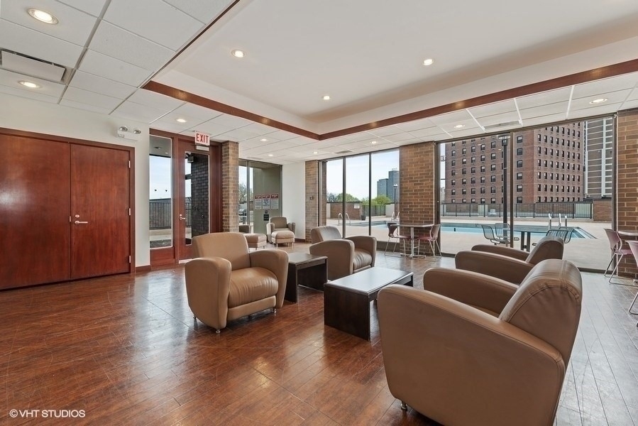 1850 North Clark Street, Unit 503 Chicago, IL 60614 - Photo 21 of 24 a living room with furniture and a large window