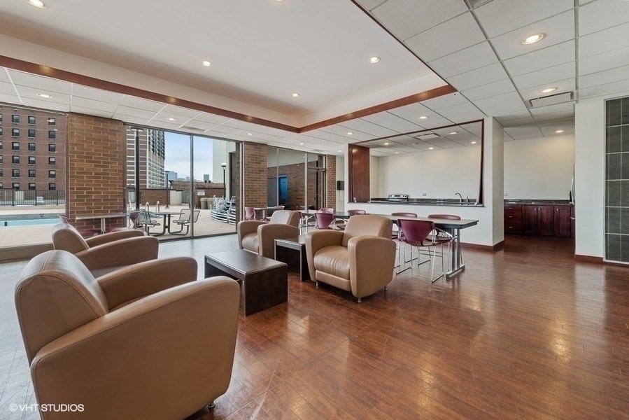 1850 North Clark Street, Unit 503 Chicago, IL 60614 - Photo 22 of 24 a living room with furniture and a large window