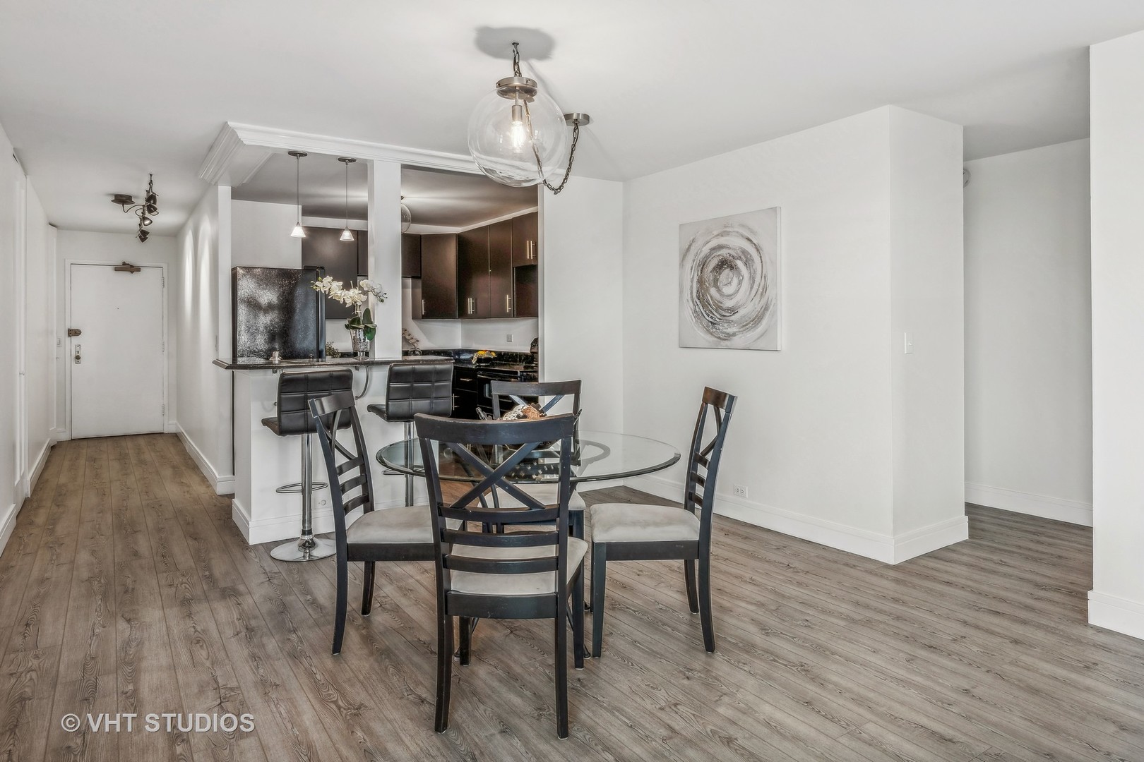 1850 North Clark Street, Unit 503 Chicago, IL 60614 - Photo 6 of 24 a view of a dining room with furniture and wooden floor