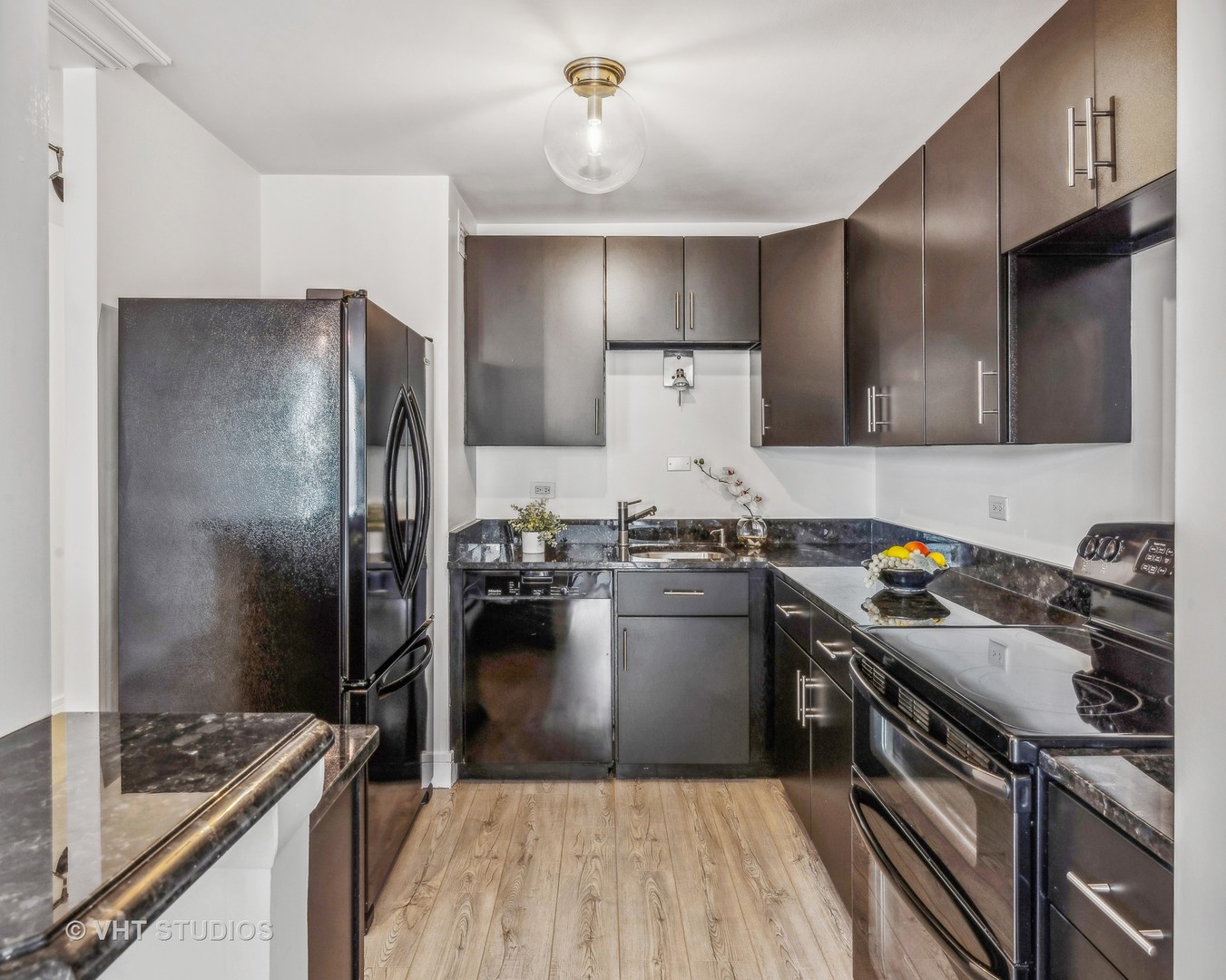 1850 North Clark Street, Unit 503 Chicago, IL 60614 - Photo 8 of 24 a kitchen with a refrigerator stove and sink