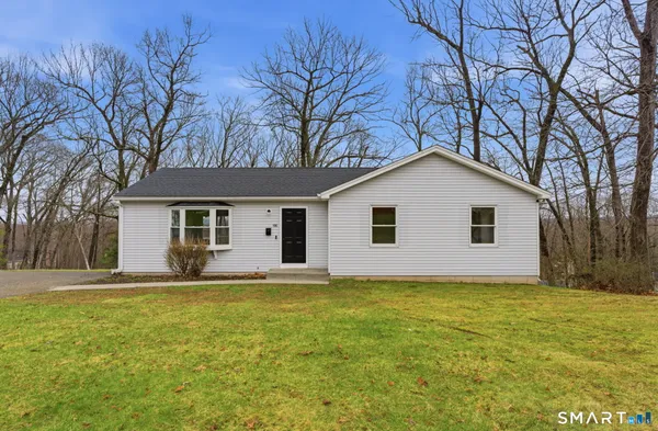 a house that has a big yard with large trees